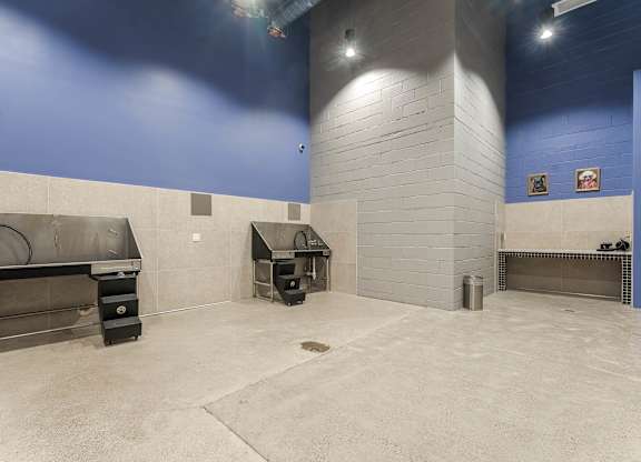Indoor grilling area with commercial smokers and blue walls at AMP 30 Apartments, California, 92116