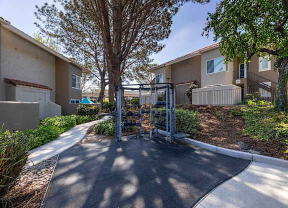 A residential area with a gate and a tree.