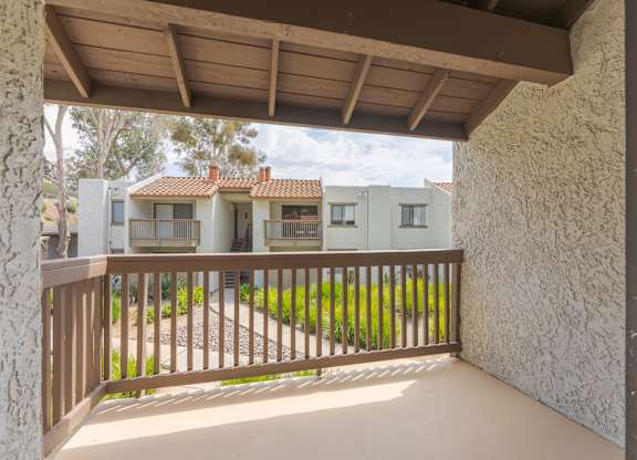 A balcony with a view of a row of houses.