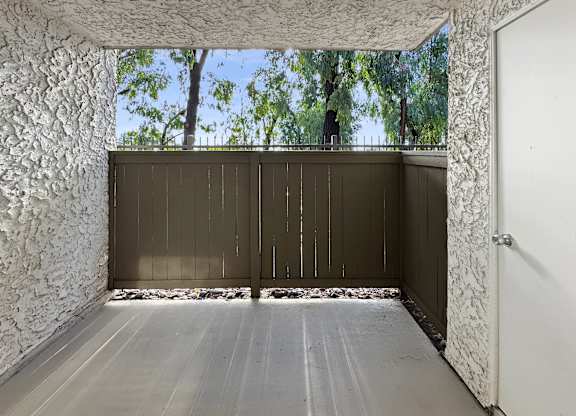 A room with a white door and a wall with a white pattern.