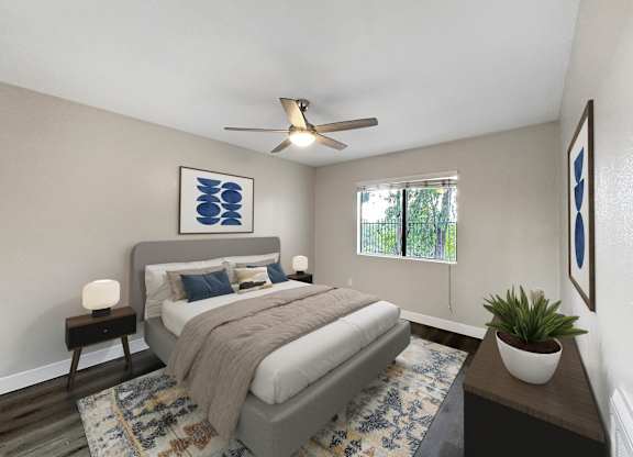 A bedroom with a bed, a ceiling fan, and a rug.