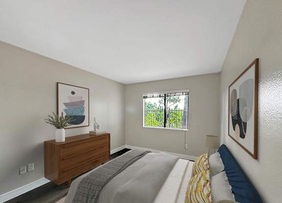 A bedroom with a bed, dresser, and two pictures on the wall.