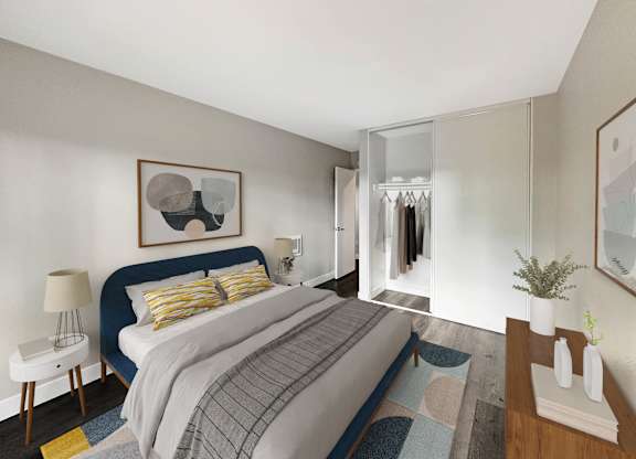 A bedroom with a bed, nightstand, and a painting on the wall.