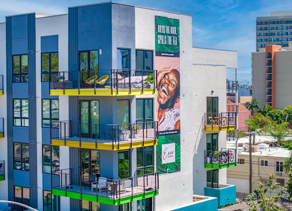 A modern building with a large advertisement on the side.
