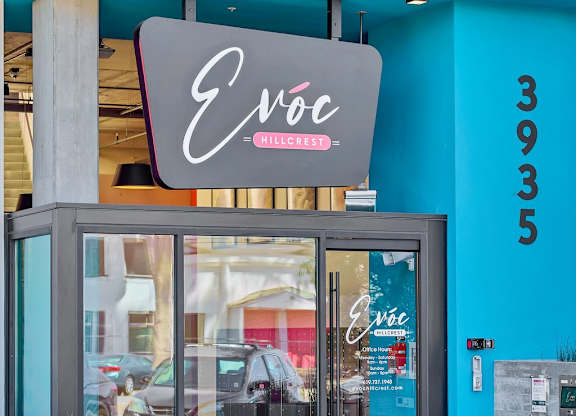 The front of a building with a glass door and a sign that says