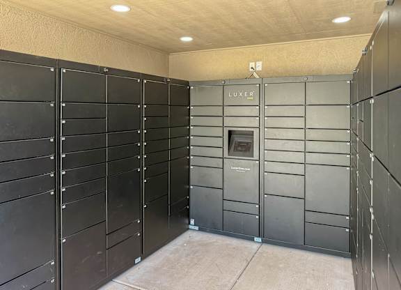 A row of black lockers with a sign that says