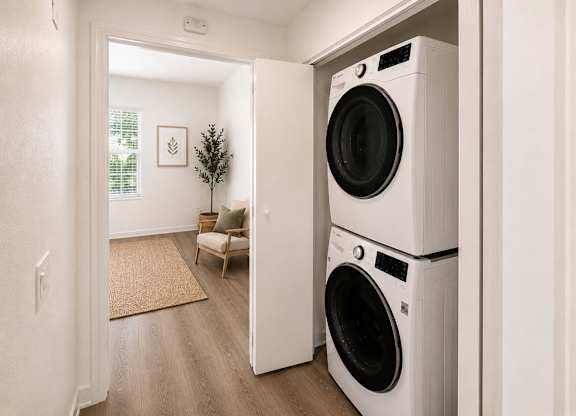 A white washing machine is in a doorway.