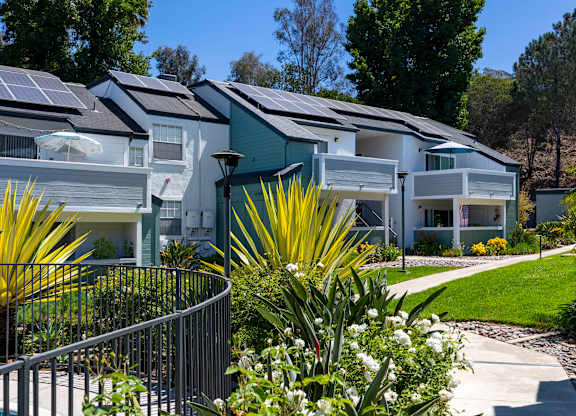 A row of houses with solar panels on the roofs.