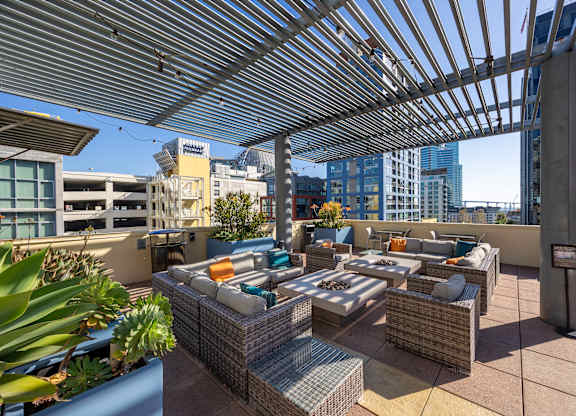 A patio with a table and chairs under a roof.