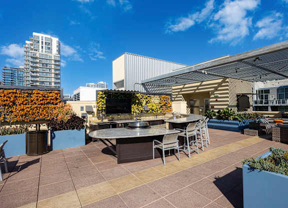A patio with a table and chairs is surrounded by buildings.