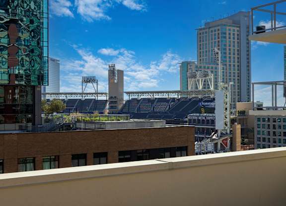 A cityscape with a clear blue sky and a bridge in the distance.