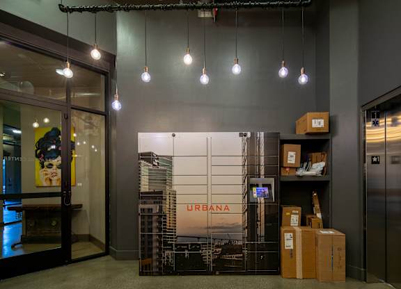 A box with the word URBANA on it is on a shelf in a room.