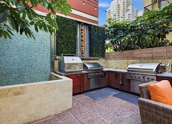 A patio with a grill and a sign that says