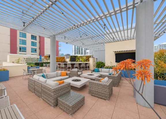 Rooftop lounge with pergola and fire pit seating at Urbana Apartments, San Diego, California