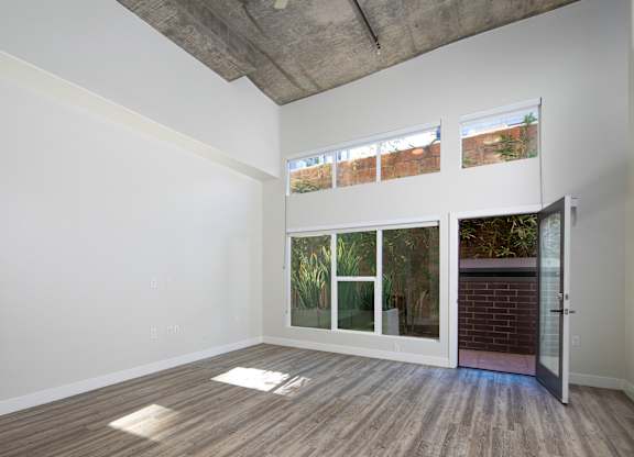 A room with a white wall and a wooden floor.