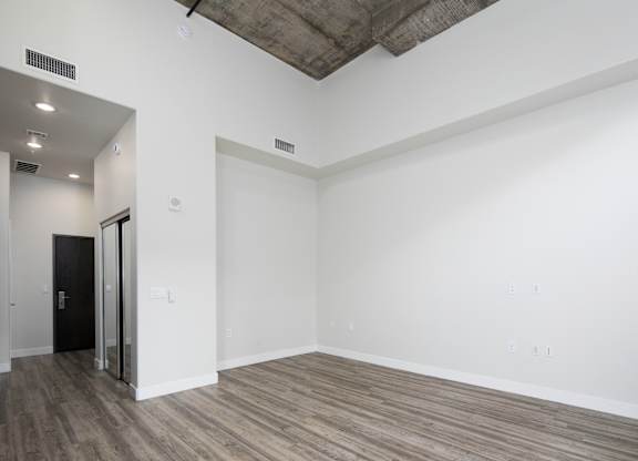 A room with a wooden floor and white walls.