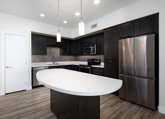 A modern kitchen with a large island in the middle.