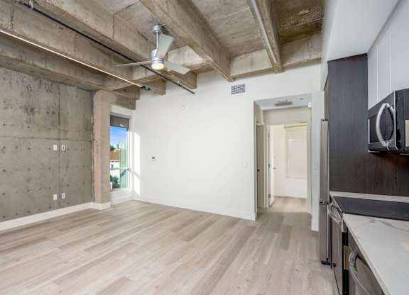 A room with a concrete wall and wooden floor.