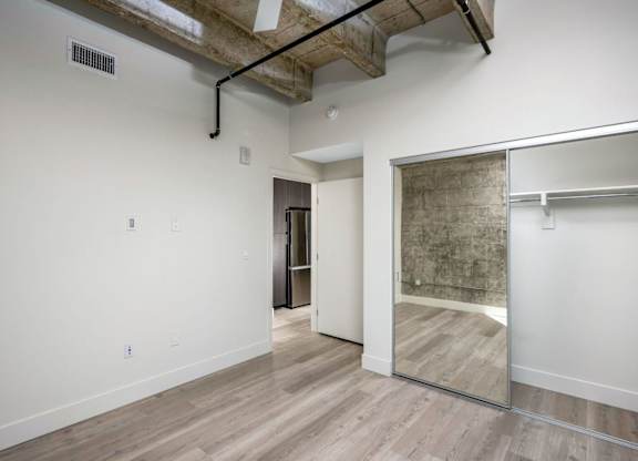 A room with a white wall and a wooden floor.