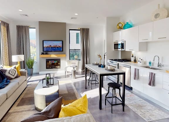 A modern living room with a grey sofa and a television.