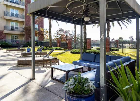 A patio with a table and chairs under a canopy.