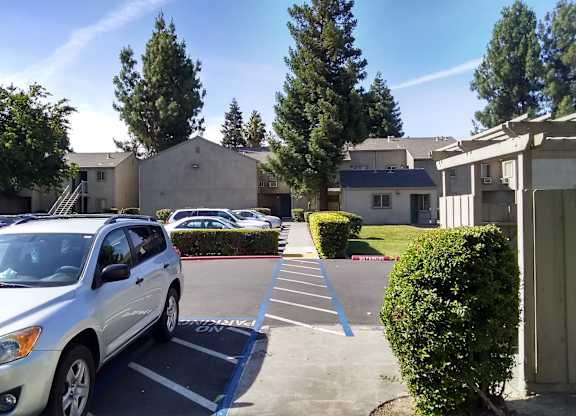 Colonial Farms Apartments - view of parking lot with apartment buildings in the background