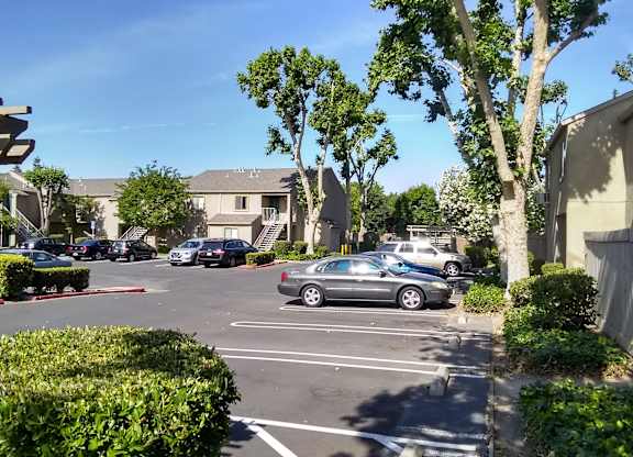Colonial Farms Apartments - view of parking lot with apartment buildings in the background