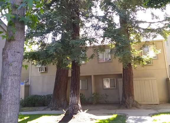 Colonial Farms Apartments - apartment building with trees and grass out front