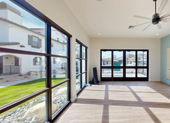 a living room with large windows and a ceiling fan at The Villas at Anacapa Canyon, California