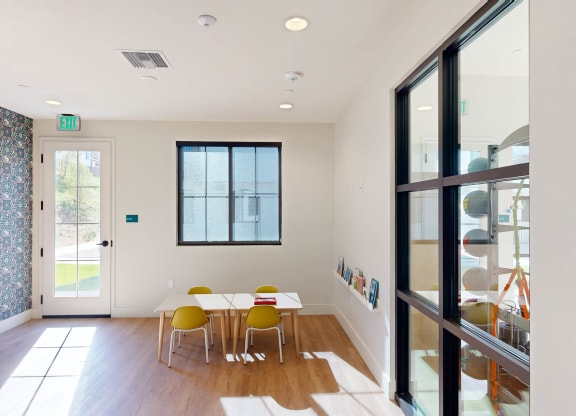 a dining room with a table and chairs and a glass door at The Villas at Anacapa Canyon, Camarillo, CA, 93012