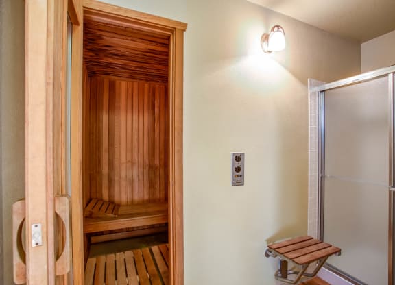 a sauna room with a shower and a wooden bench at Valley Plaza Villages, California, 94566