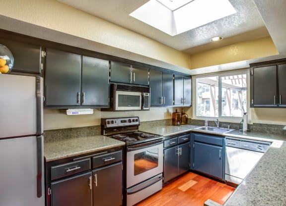 a kitchen with stainless steel appliances and granite counter tops at Valley Plaza Villages, California, 94566