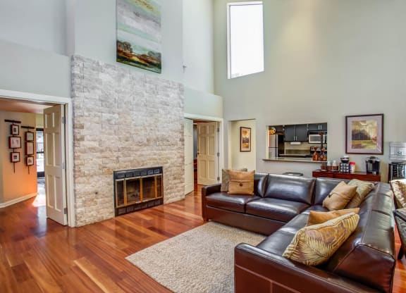 a living room with leather furniture and a stone fireplace at Valley Plaza Villages, Pleasanton, 94566