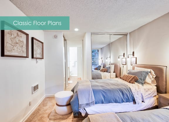 a bedroom with a bed and a mirrored closet at The Meadows Apartments, California, 90230