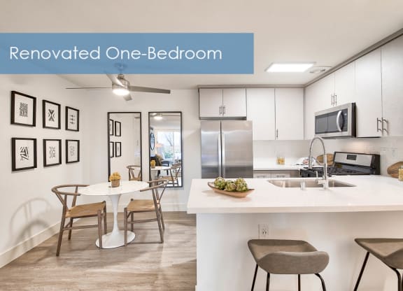 a renovated one bedroom apartment with a kitchen and a dining table at The Meadows Apartments, Culver City , 90230