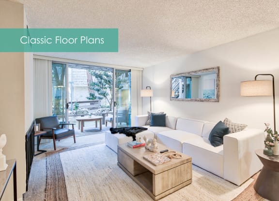 a living room with a white couch and a table at The Meadows Apartments, Culver City , 90230