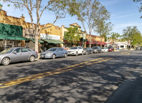 a row of cars parked on the side of a street  at Pleasanton Place, Pleasanton, CA, 94566