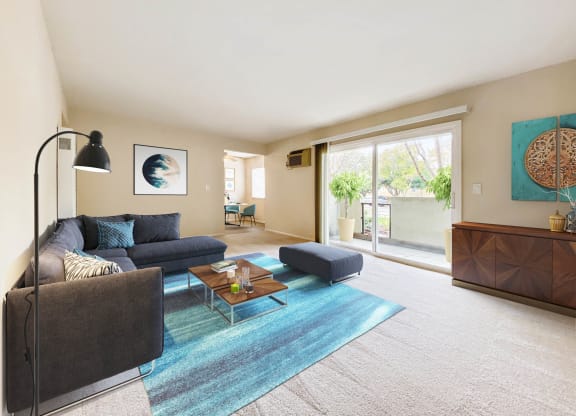 a living room with a couch and a coffee table and a sliding glass door  at Pleasanton Place, California, 94566