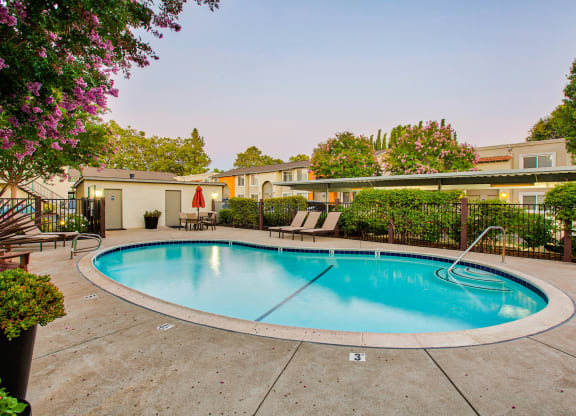a resort style pool with chairs and a fence around it  at Pleasanton Place, California