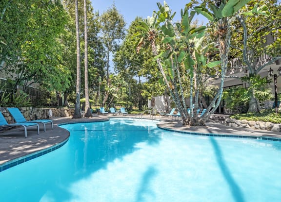 a swimming pool at a resort with trees and chairs  at Rancho Los Feliz, Los Angeles