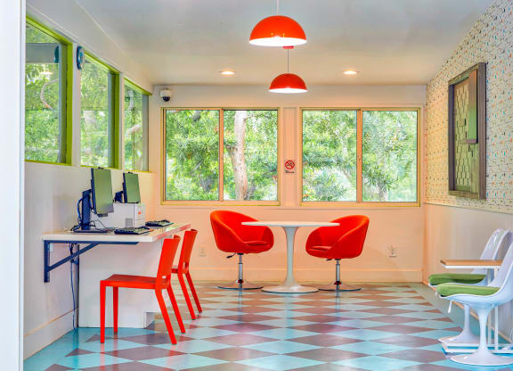 an office with red chairs and a table with a computer  at Rancho Los Feliz, Los Angeles, CA, 90039