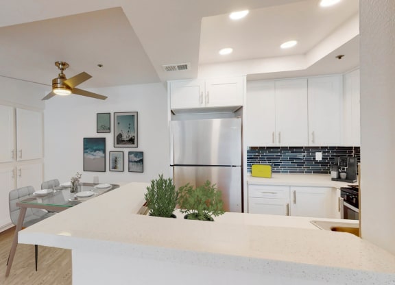a kitchen with a white counter top and a stainless steel refrigerator at Sendero Huntington Beach, California, 92647