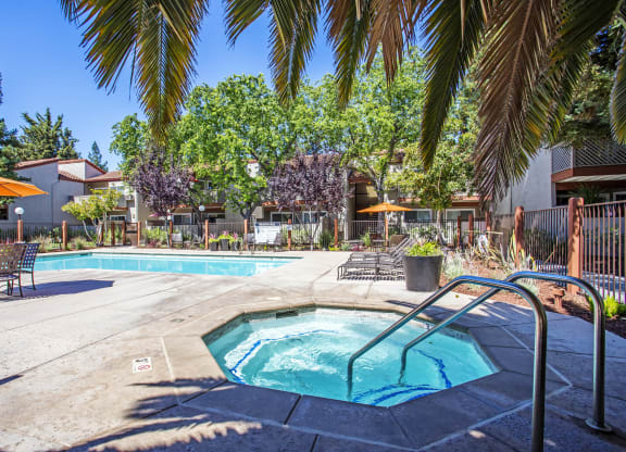 our apartments have a swimming pool and a patio with umbrellas at Valley Plaza Villages, Pleasanton, 94566