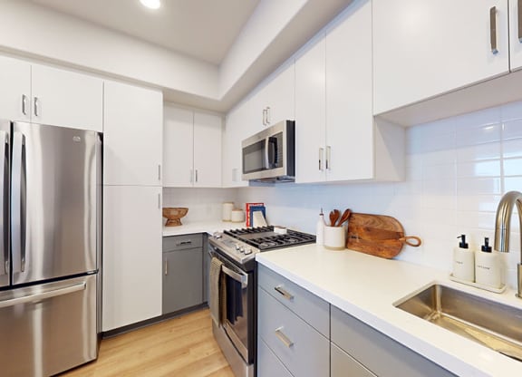 a kitchen with stainless steel appliances and white cabinets at The Villas at Anacapa Canyon, California