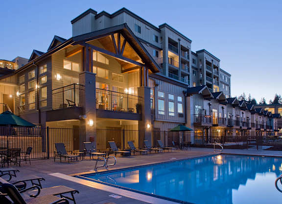 A large building with a pool in front of it.