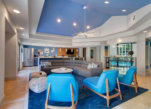 A living room with a blue couch and chairs.