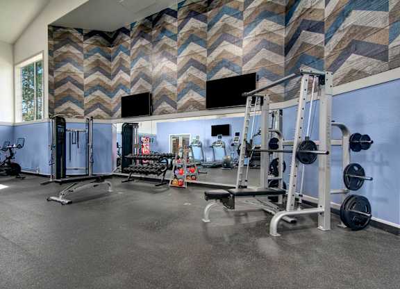 A spacious home gym with a variety of exercise equipment.