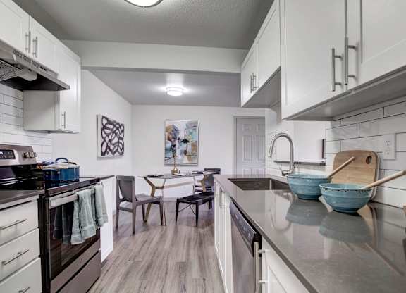 A modern kitchen with a dining table and chairs.