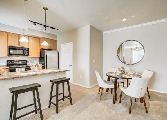 an open kitchen and dining area with a dining table and chairs  at Adiamo Palm Valley, Goodyear, Arizona