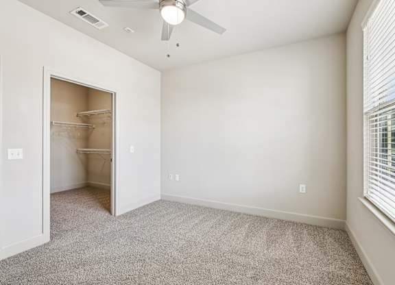 A room with a ceiling fan and a doorway leading to another room. at North Creek, Texas